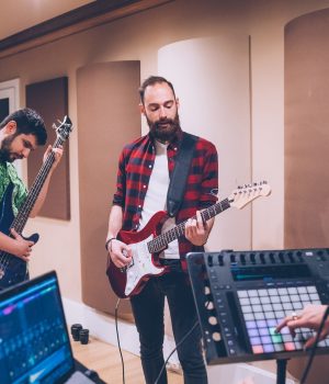 Bassist ang guitarist playing together having fun Bassist ang guitarist playing together having fun